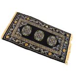 Chinese wool rug, black field with medallions, 97cm x 180cm Condition: **General condition