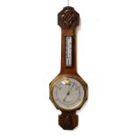 Early 20th Century oak cased aneroid barometer and thermometer with carved decoration, 79cm high,