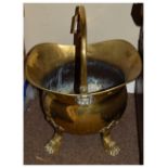 Late 19th/early 20th Century brass helmet shaped coal bucket standing on four claw feet with loop