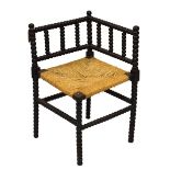 Early 20th Century ebonised bobbin-turned corner chair having seagrass seat, 66.5cm x 42cm x 42cm