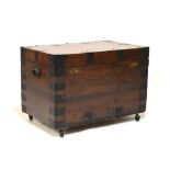 20th Century metal bound campaign style chest with hinged lid and standing on four later castors,