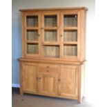 Modern light oak dresser, the base fitted three cupboards and two short drawers, the upper section