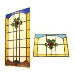 Five early 20th Century stained glass panels with floral motifs, the largest measuring 120cm x 58cm,