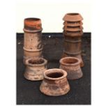 Two Victorian tall terracotta chimney pots, the largest measuring 80cm high, together with three