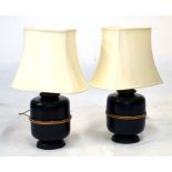 Pair of Oriental style table lamps, the bases formed as black bamboo bound urns, 63cm high with