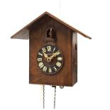 20th Century carved wooden cuckoo clock with geometric decoration and pine cone weights Condition: