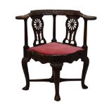 18th Century walnut 'smoker's bow' corner arm chair, later carved, the curved top rail with