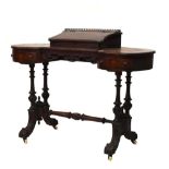 Late Victorian shaped kidney writing table, with integral raised writing slope standing on four