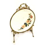 Early 20th Century brass framed mirror fire screen with floral painted decoration, 66cm high