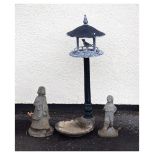 Two modern figural garden ornaments, together with an aluminium bird table standing on a shell