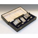 Elizabeth II three piece silver condiment set of wavy cartouche form with pierced decoration and