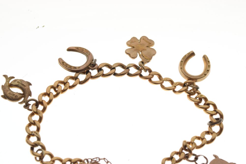 18ct gold curb link bracelet set with assorted gold and yellow metal charms and a plated padlock, - Image 3 of 5