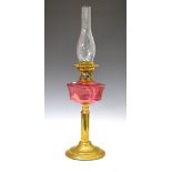 Brass and cranberry glass oil lamp and funnel, overall height 65cm Condition: **Due to current
