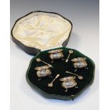 Four Edward VII silver cauldron salts, standing on three paw feet, in fitted case with retailers