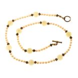Cultured pearl and carved celadon jade necklace with nine carved jade ball spacers, 51.5cm long