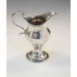 George II silver cream jug standing on circular pedestal base with scroll handle, London 1772,