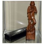 Black Forest style carved figure of a gentleman smoking a pipe, 35cm high, together with an Oriental