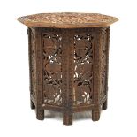 Eastern heavily carved hardwood octagonal top table with folding pierced base, 46cm diameter