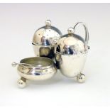Edward VII silver condiment set of egg shape design with scroll handle and standing on three ball