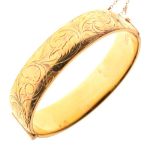 Yellow metal snap bangle, stamped 9ct metal core, 16mm wide, 30.7g gross approx Condition: ** Due to
