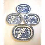 Four blue and white transfer printed Willow pattern meat plates, the largest 45cm wide Condition: