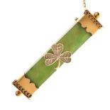 Unmarked yellow metal and nephrite jade bar brooch set with central shamrock motif, 5.8cm wide, 10.