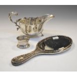 George VI silver sauce boat with scroll handle and standing on three claw feet, London 1939,