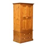 Modern waxed pine wardrobe or press cupboard with twin panelled doors over two drawers, 96cm x