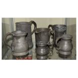 Collection of 19th Century pewter mugs etc, the largest quart mug standing 16cm high Condition: