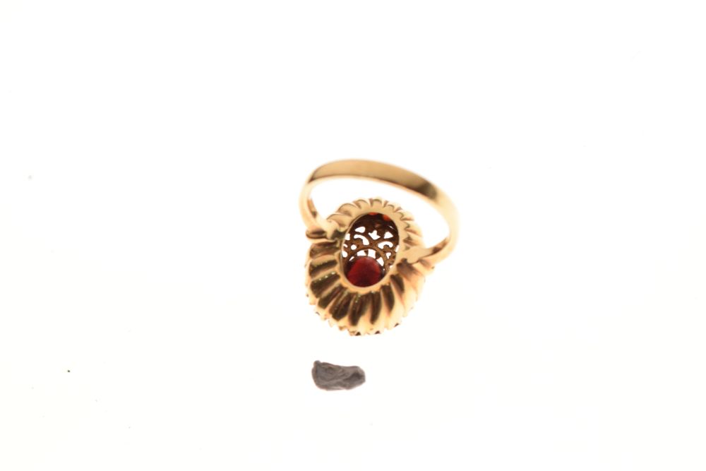 Yellow metal and red garnet-coloured stone dress ring with faceted oval stone and matching border, - Image 4 of 5