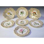 Seven Victorian dessert plates, all having central floral decoration, surrounded with gilt