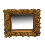 Late 19th or early 20th Century gilt plaster-framed wall mirror with bevelled plate in foliate
