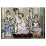 Lladro porcelain figure of a girl on a telephone, together with six Nao porcelain figures, 25cm high