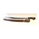 Indonesian sabre having carved wooden grip, in wooden sheath, blade approx 60cm long Condition: