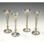 Set of four Victorian silver bud vases with splayed rims, 14cm high Condition: Several vases have