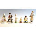 Five 19th Century Continental porcelain figures in 18th Century style and a fairing, 13.5cm high and