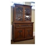 Early 20th Century Art Nouveau-style carved oak secretaire bookcase on cabinet, the upper section