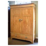 Stripped pine wardrobe enclosing hanging space over two base drawers, 150cm x 60cm x 207cm high