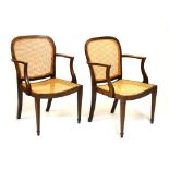 Pair of early 20th Century mahogany armchairs with cane seats and backs Condition: Staining and