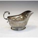 George V silver sauce boat with scroll handle and standing on pedestal base, Birmingham 1935, 110g