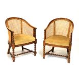 Two mahogany barley twist Bergère chairs with woven cane backs Condition: Areas of broken cane,