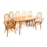 Ercol Golden Dawn elm dining room suite of table, four chairs, two armchairs Condition: Table top