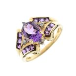 9ct gold dress ring set faceted oval amethyst-coloured central stone flanked by two small diamonds