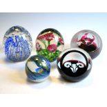 Five decorative glass paperweights including examples by Caithness, 10cm high and smaller Condition: