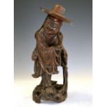 Hardwood figure of a priest, 30cm high excluding hat Condition: Hat has been split to one side,