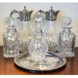 Quantity of modern cut glass decanters and claret jugs with reproduction porcelain labels and plated