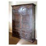 Early 20th Century oak wardrobe in the late 17th Century geometric style enclosing hanging space,