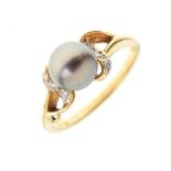 Yellow metal dress ring set tinted pearl between small diamonds, shank stamped 18k/750, size L½, 3.
