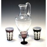 Early 19th Century amethyst glass egg cup, together with two overlaid window-cut beakers and a