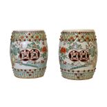 Two 20th Century Chinese porcelain barrel shaped garden seats, foliate decoration, on a white